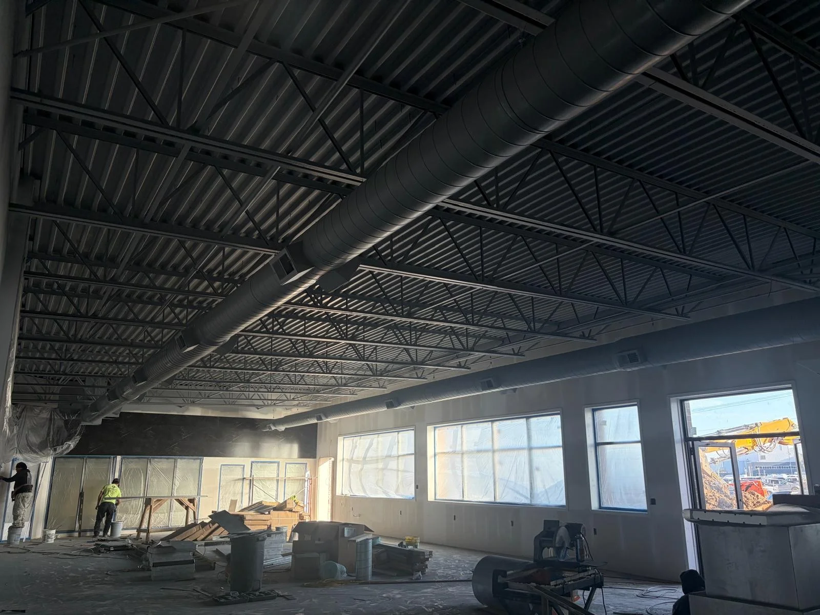 Commercial exposed round spiral ductwork installation in open ceiling